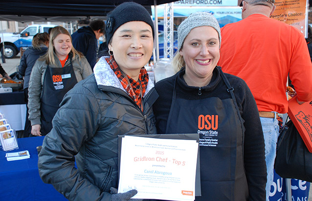 Ecampus student Carol Abrogoua, right, poses with Moore Family Center director Emily Ho at the GridIron Chef Contest.