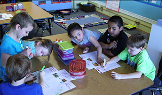 First graders in a dual language program work on a project.