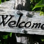 Wooden sign with the word welcome on it.