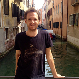 Ryan Fox, wearing a black t-shirt, stands in front of a canal.