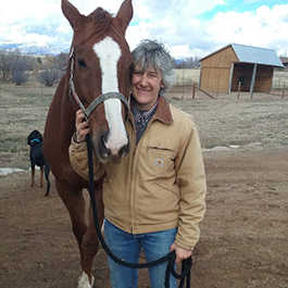 Rangeland sciences instructor Yvette Gibson with her horse, Oliver, on her ranch in Colorado.