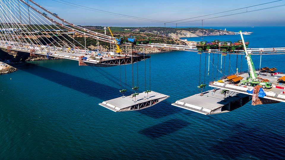 Bridge construction over water with cranes demonstrating real-world civil engineering applications