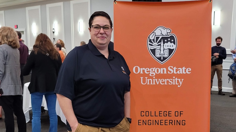 Daniele Safonte poses in a black polo shirt in front of an orange College of Engineering sign.