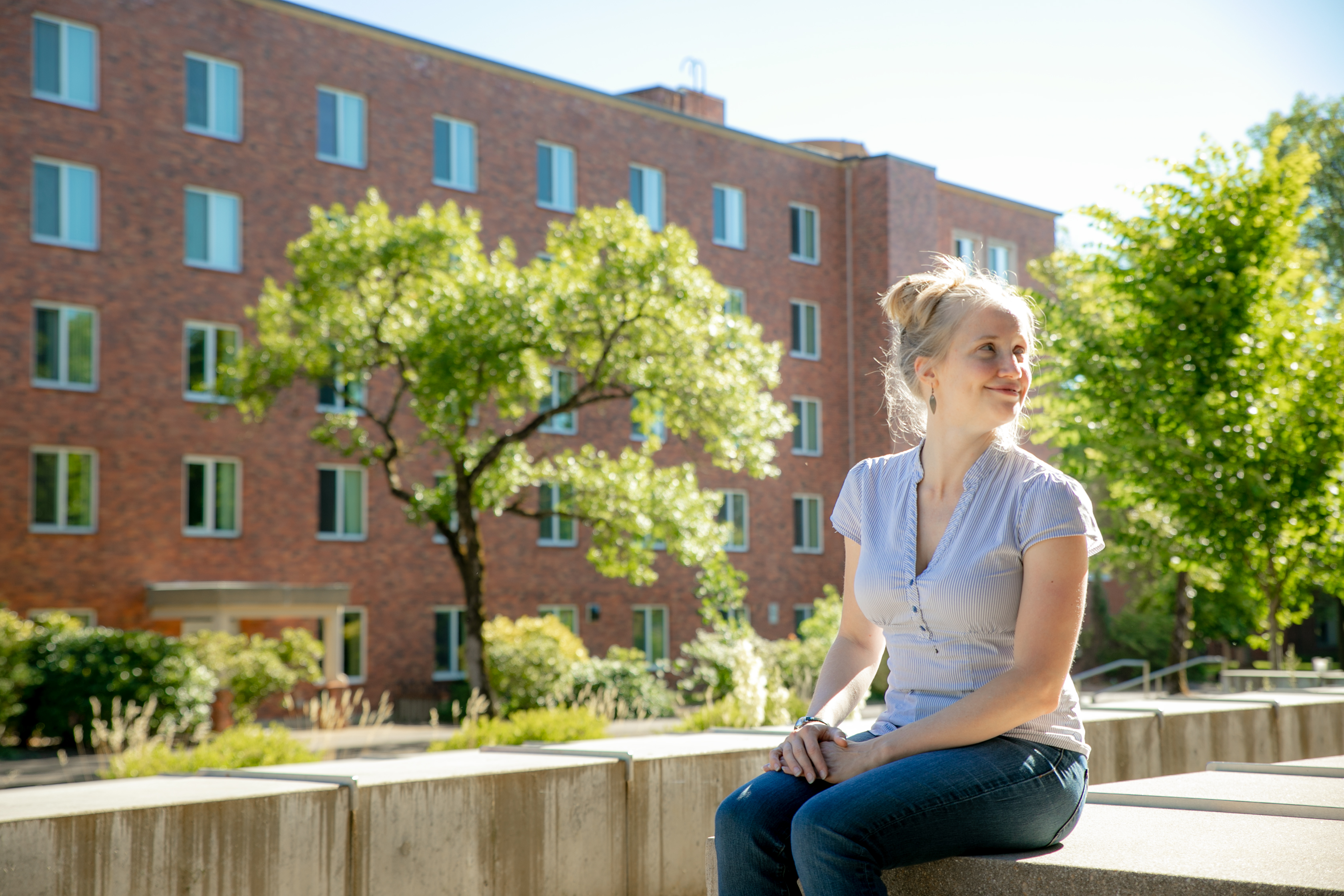 Heather Bell, radiation health physics student, sits outdoors on the OSU Corvallis campus.