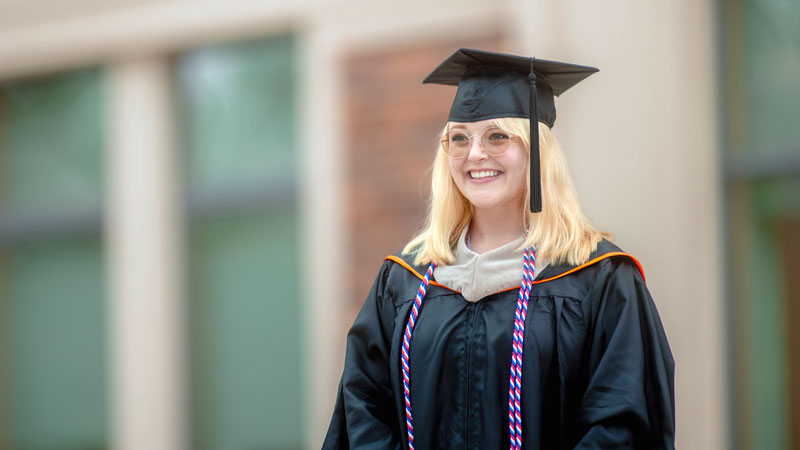 Kaitlin Thurman, a master's in environmental sciences graduate, wearing a cap and gown