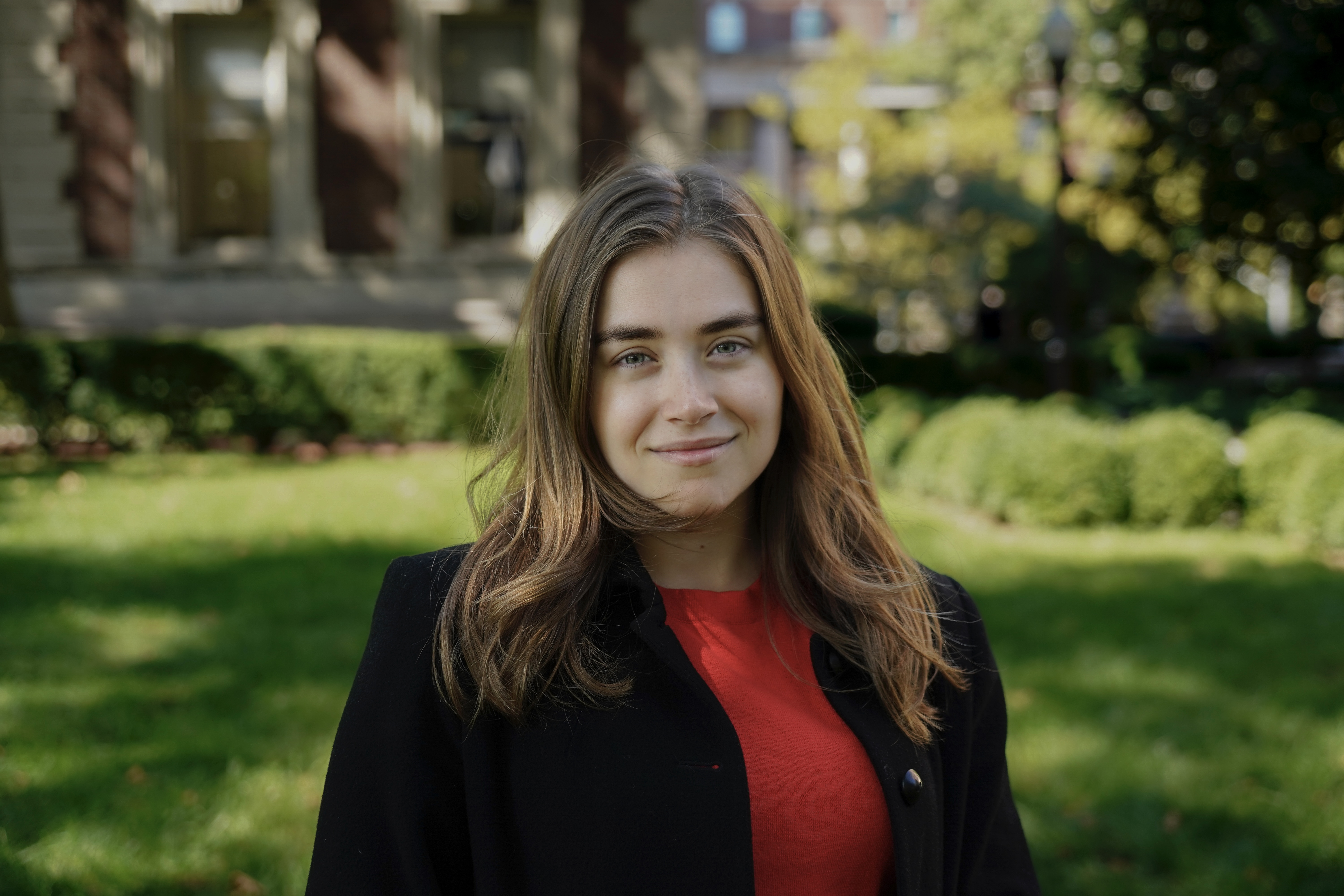 Oregon State student Michelle Cimino stands outside while smiling with green grass behind her.