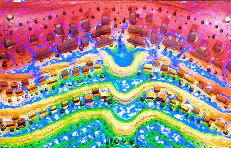 The augmented reality sandbox used in Permaculture Design and Theory course online shows how landscape design affects water flow.