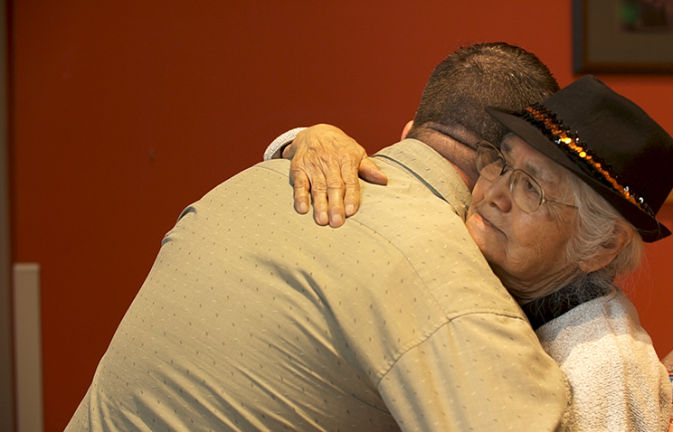 Orman hugs a Native elder whom he met at the Oregon State University Native American Longhouse Eena Haws.