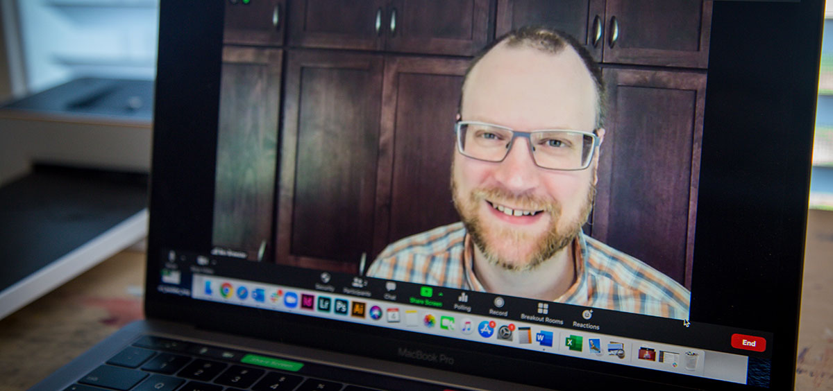 Ben Brewster smiles from a video stream on the photographer's laptop