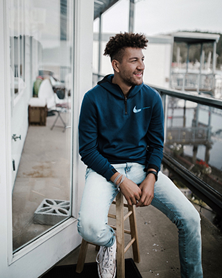 Business administration student, Josh Griffie poses on a stool