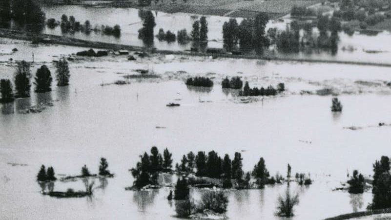 A black and white photo of a flooded community taken from above showcases the extent of the Vanport disaster.