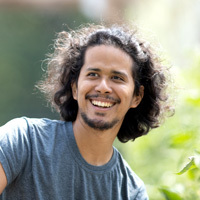 Joshua Chan Burgos, OSU Ecampus Anthropology graduate, smiles